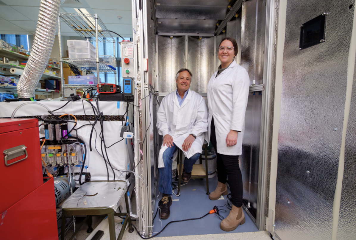 Professor Mark Hernandez and doctoral graduate Marina Nieto-Caballero stand inside a bioaerosol chamber in the Environmental Engineering disinfection laboratory at the Sustainability, Energy and Environment Complex (SEEC). Photo by Patrick Campbell/CU Boulder.